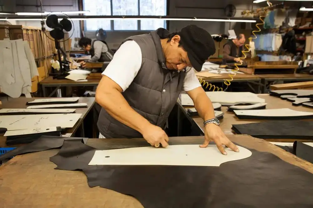 Custom leather jacket pattern cutting in workshop