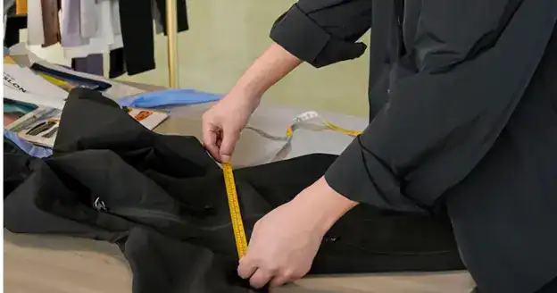 Startup founder reviewing a jacket sample with a manufacturer