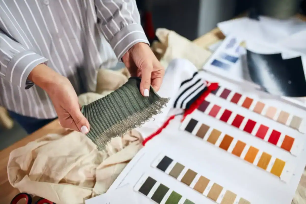 OEM factory reviewing a tech pack and clothing sample