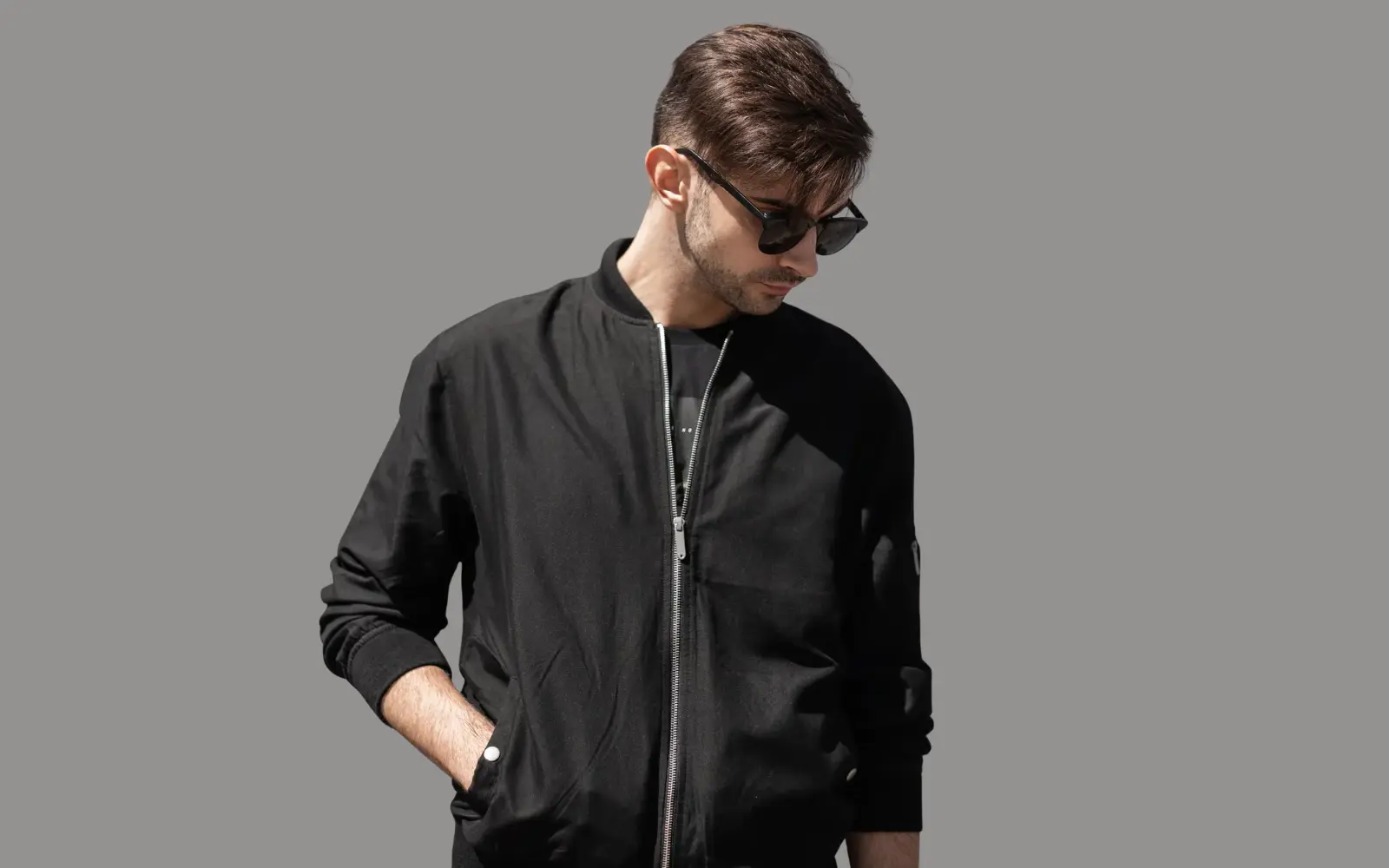 Bomber jacket construction with ribbed cuff, lining, zipper, and pocket